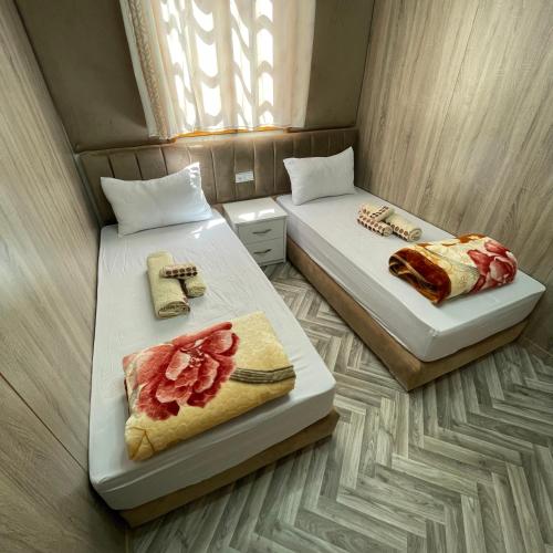 two beds in a small room with food on them at Camping Riad Maissa in Dou Tourga