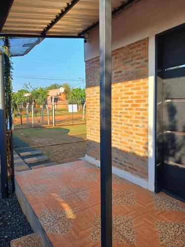 a patio with a brick wall and a building at La casita de Miguel in Villarrica