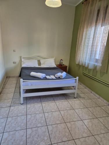 a bedroom with a bed with towels on it at Old Town Apartment in Kavala