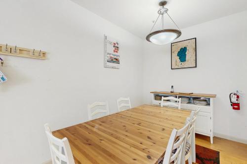 a dining room with a wooden table and chairs at Olympic Pines Lodge in Olympic Valley