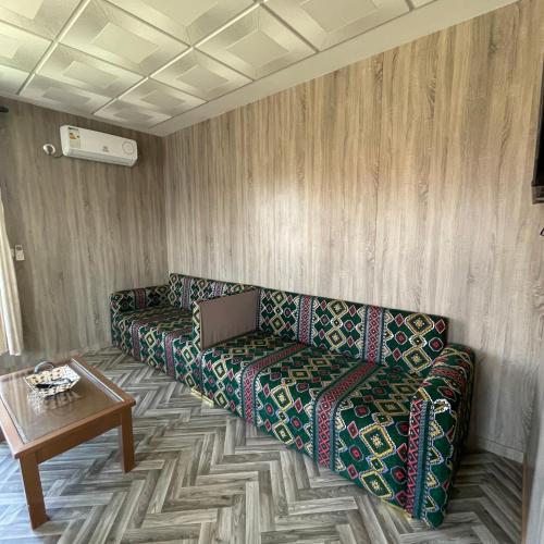 a living room with a couch and a table at Camping Riad Maissa in Dou Tourga