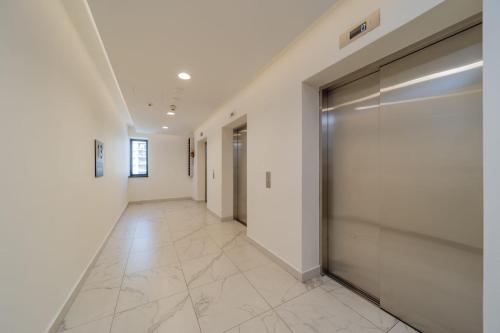 a hallway with a large metal door in a building at Predator in Sajmište