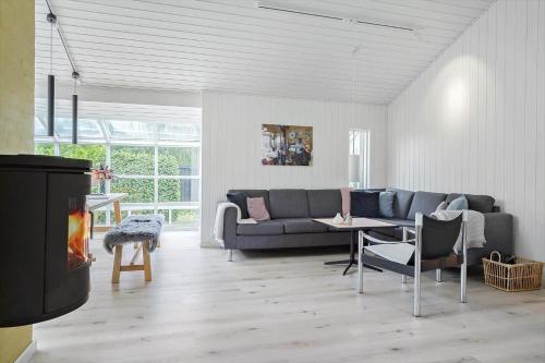 a living room with a couch and a table at 40106-Juelsminde-Fasanlunden-34 in Juelsminde