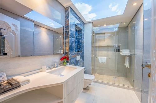 a bathroom with a sink and a shower and a toilet at World Heart Residences in Baghdad