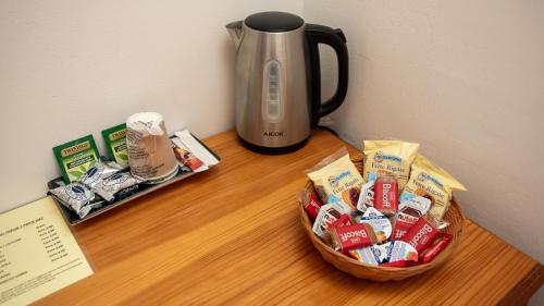 a table with a basket of food and a coffee pot at Tenuta dell'Argento Pool&Relax by Rentbeat in Civitavecchia