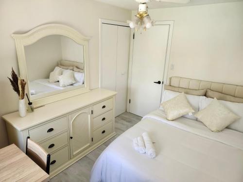 a bedroom with two beds and a mirror at 3Q Ltd in Hamilton