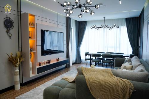 a living room with a couch and a dining room at TOP VIEW Luxury 2 bedrooms in Dubai only families in Dubai