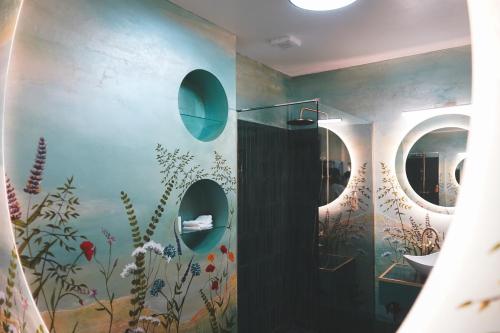 a bathroom with a shower with a painting on the wall at Conacul Archia in Deva