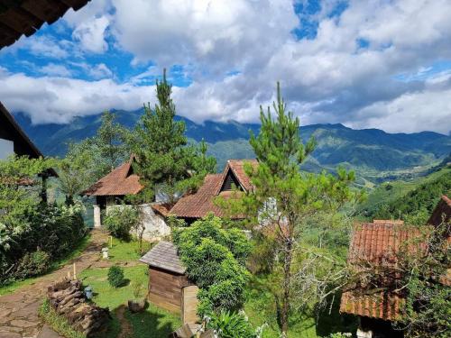 an image of a house with mountains in the background at Sapa Heaven - Sapa Jade Hill in Sa Pa