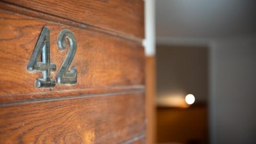 a close up of a wooden door with the number four at Tenuta dell'Argento Pool&Relax by Rentbeat in Civitavecchia