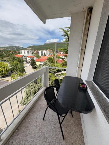 a black table and chairs on a balcony at La casa Mia in Posušje