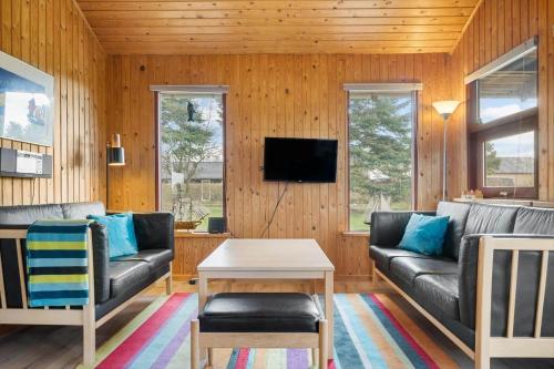 a living room with a couch and a table at 30168-Odder-Pouli-Nielsensvej-3 in Beder
