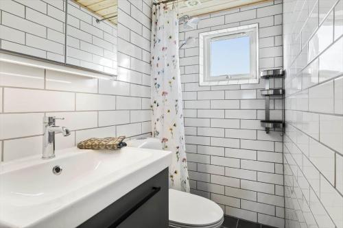 a white bathroom with a sink and a toilet at 30189-Malling-Fjordvej-52 in Malling