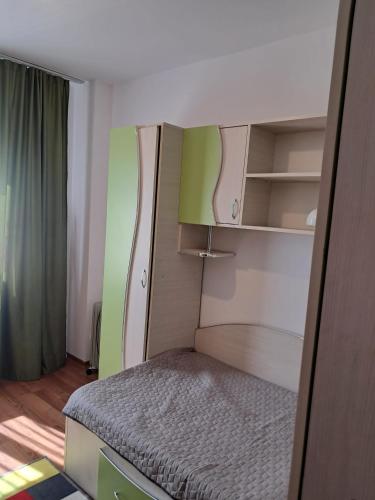 a small bedroom with a bed in a room at Adrian in Piteşti
