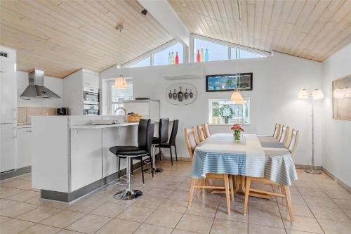 a kitchen and dining room with a table and chairs at 30516-Odder-Birkevaenget-7 in Odder