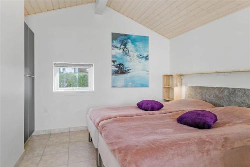 a bedroom with two beds with purple pillows on them at 30516-Odder-Birkevaenget-7 in Odder
