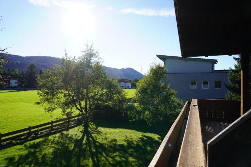 a view from the balcony of a house with a tree at Panorama Appartements in Itter