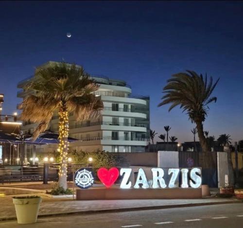 a sign that says zarisks in front of a building at Diar el bahar zarzis sonia marina in Zarzis