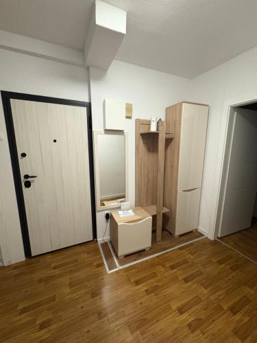 an empty room with a white door and a mirror at La casa Mia in Posušje