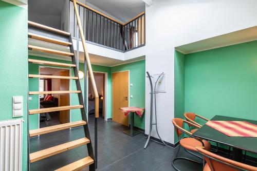 a dining room with a staircase and a table and chairs at Bacchus Holiday Homes in Bacharach