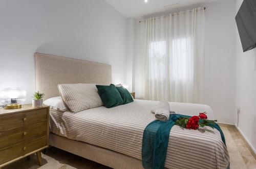 Un dormitorio con una cama y una cómoda y una ventana. en Cadiz Playa 3 Rooms, en Cádiz