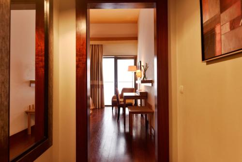 a hallway leading to a living room with a table at Pousada Convento de Tavira in Tavira