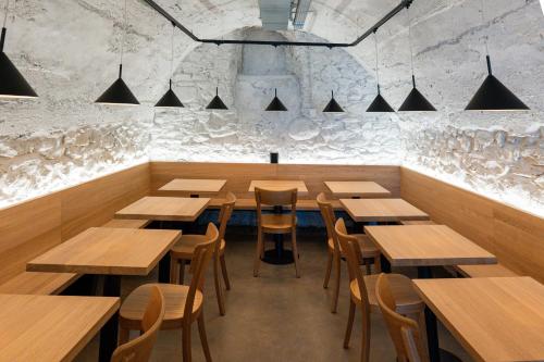 a dining room with wooden tables and chairs at Martigny Youth Hostel in Martigny-Ville