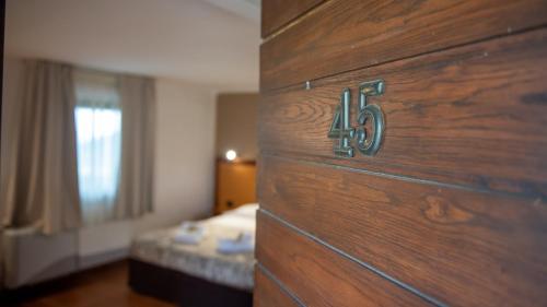 a wooden door with a number on it in a bedroom at Tenuta dell'Argento Pool&Relax by Rentbeat in Civitavecchia