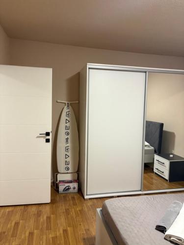 a bedroom with a white door and a surfboard at La casa Mia in Posušje
