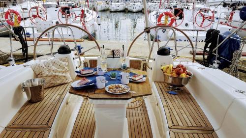 a table on a boat with a plate of food on it at Lady Butterfly in Tučepi