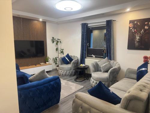 a living room with couches and a flat screen tv at Großzügige 2-Etagen-Wohnung - Garten& Natur&See in Böhlen