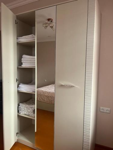 a closet with a mirror and some towels at ДАВТЯН ДОМ in Yerevan