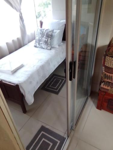 a small room with a bed and a glass door at Unit51 MarinaGlen Holiday Resort in Marina Beach