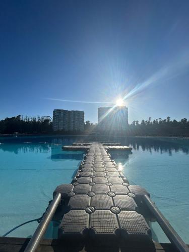 a dock in the middle of a body of water at Depto Frente a Laguna y Patio Privado in San Antonio