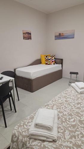 Un ou plusieurs lits dans un hébergement de l'établissement Tarantella apartment
