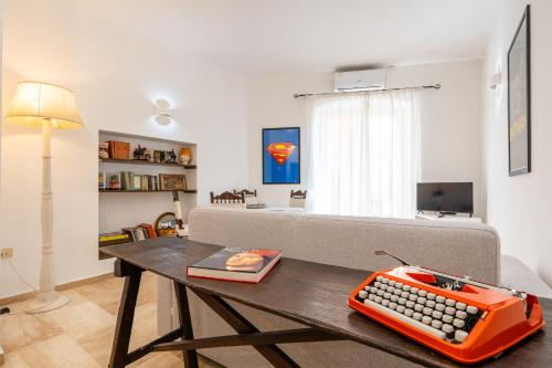 an orange keyboard sitting on a table in a living room at Panorama di mare suite via Cima Cagliari Centro in Cagliari