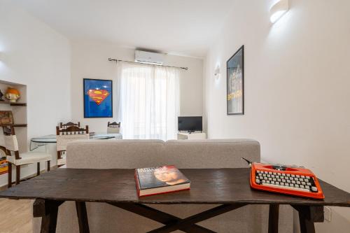 a living room with a couch and a keyboard on a table at Panorama di mare suite via Cima Cagliari Centro in Cagliari