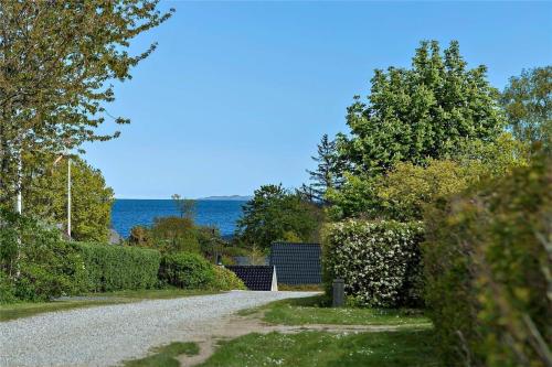 a gravel road with a view of the ocean at 30463-Odder-Solbakken-14 in Odder