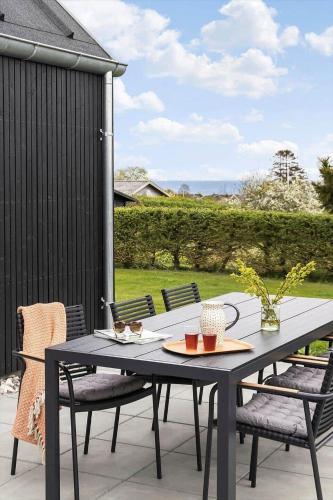 a black table and chairs on a patio at 30467-Odder-Ravnsager-15 in Odder
