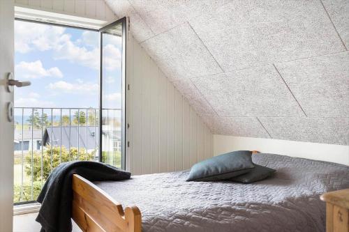 a bedroom with a bed and a large window at 30467-Odder-Ravnsager-15 in Odder