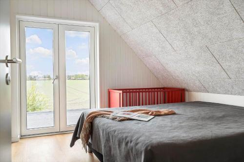 a bedroom with a bed and a large window at 30467-Odder-Ravnsager-15 in Odder
