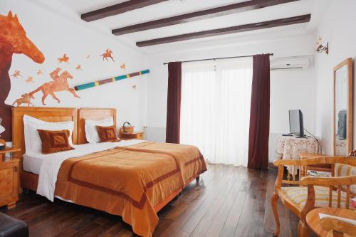 a bedroom with a bed with a dinosaur on the wall at Conacul Archia in Deva
