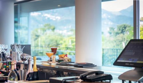 a bar with a laptop on a counter with a window at Principe Forte Dei Marmi - Resort & Spa in Forte dei Marmi