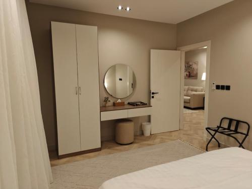 a bedroom with a mirror and a bed at Kanaf Luxury Apartment, two bedrooms and a hall in Quai