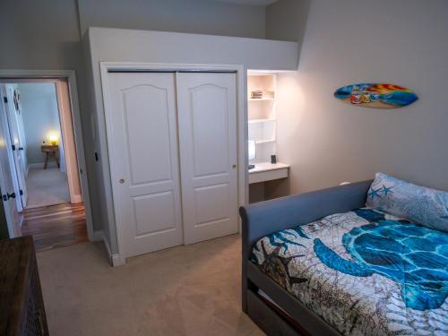 a bedroom with a bed and a door to a hallway at New! Fair Winds Private Island Oases w Heated Pool & more! in Merritt Island