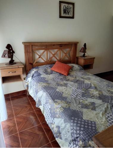 una cama en una habitación con dos mesitas de noche y una cama sidx sidx sidx en Hostal la Caleta, en Mar de Cobo