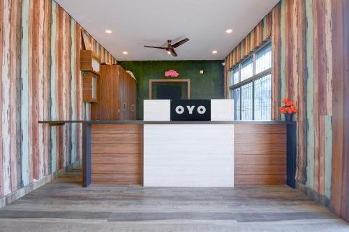 an office lobby with an ovo sign on the counter at Hotel O THE WEDDING RINGS in Dhanbād