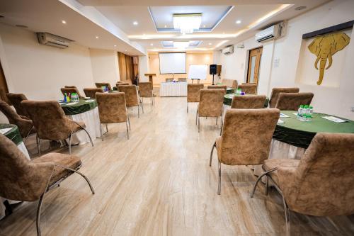 a conference room with tables and chairs and a podium at SoonStay Hotel Konark in Indore