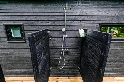 a black wall with a shower and a phone at 30159-Odder-Thorasvej-24 in Beder