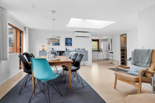 a dining room and living room with a table and chairs at 40157-Juelsminde-ElmeAlle-22 in Juelsminde